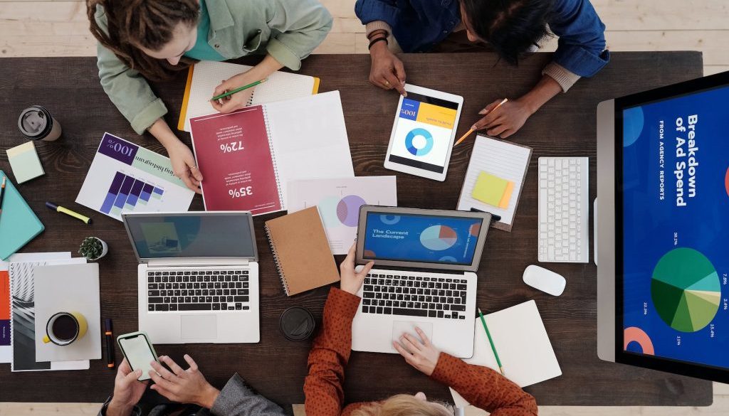 a group of people discussing charts